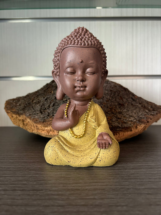 Figura buda niño meditando.
