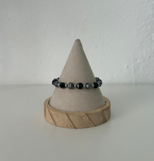 La pulsera ajustable de hematite y onix facetado.