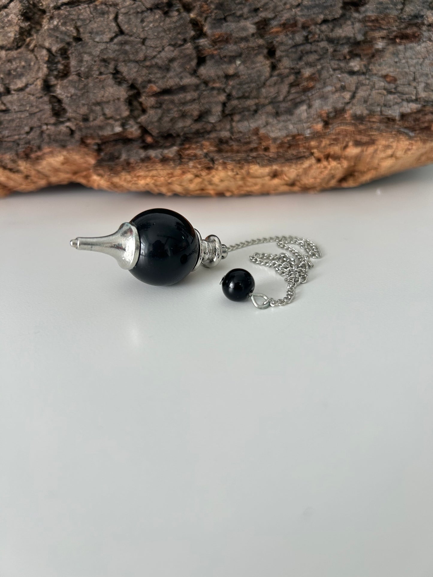 Péndulo de metal con onix